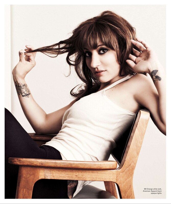 woman with tattoos on chair