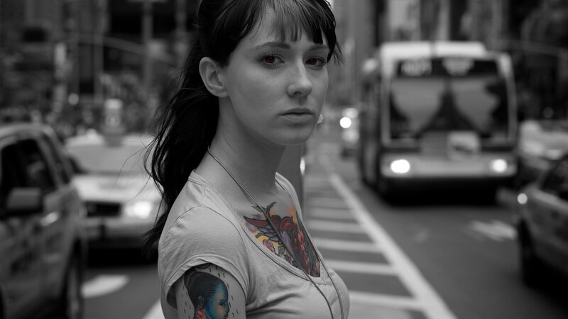 woman with tattoos on city street