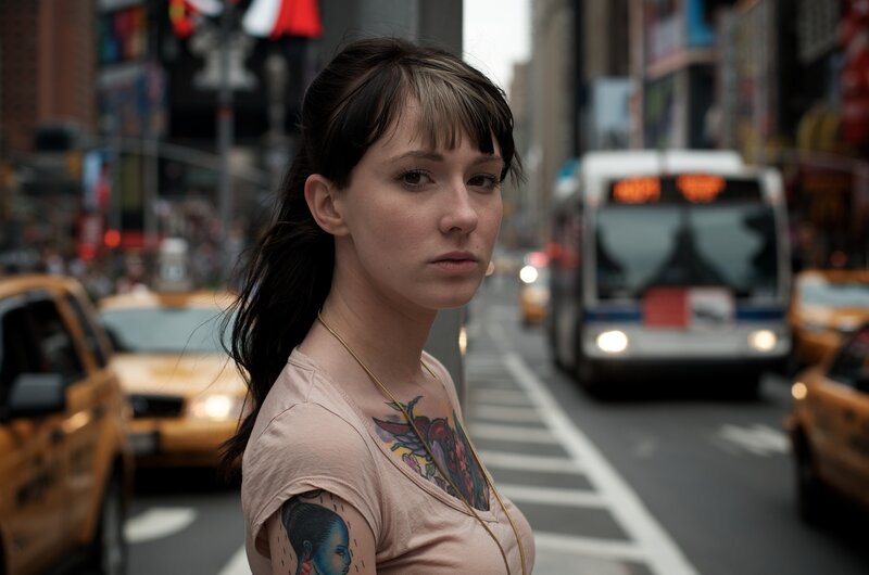 woman with tattoos on city street