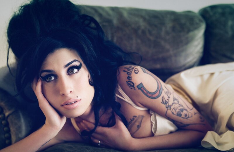 woman with tattoos on couch