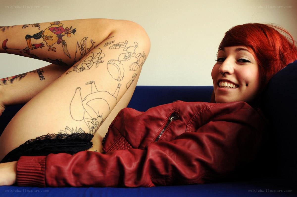 woman with tattoos on couch