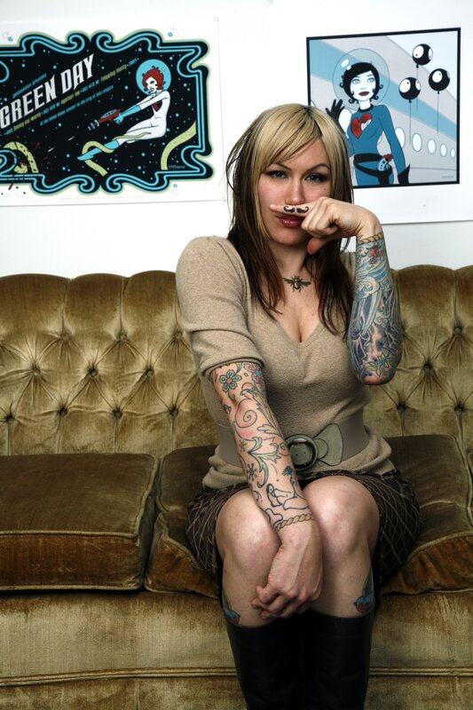 woman with tattoos on couch