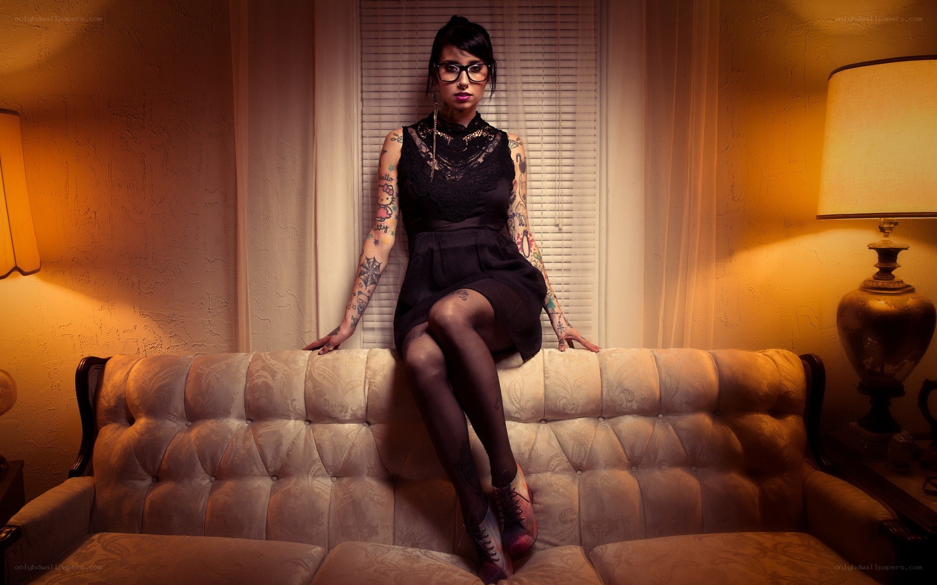 woman with tattoos on couch