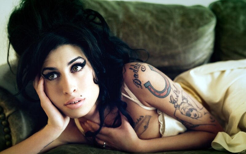 woman with tattoos on couch