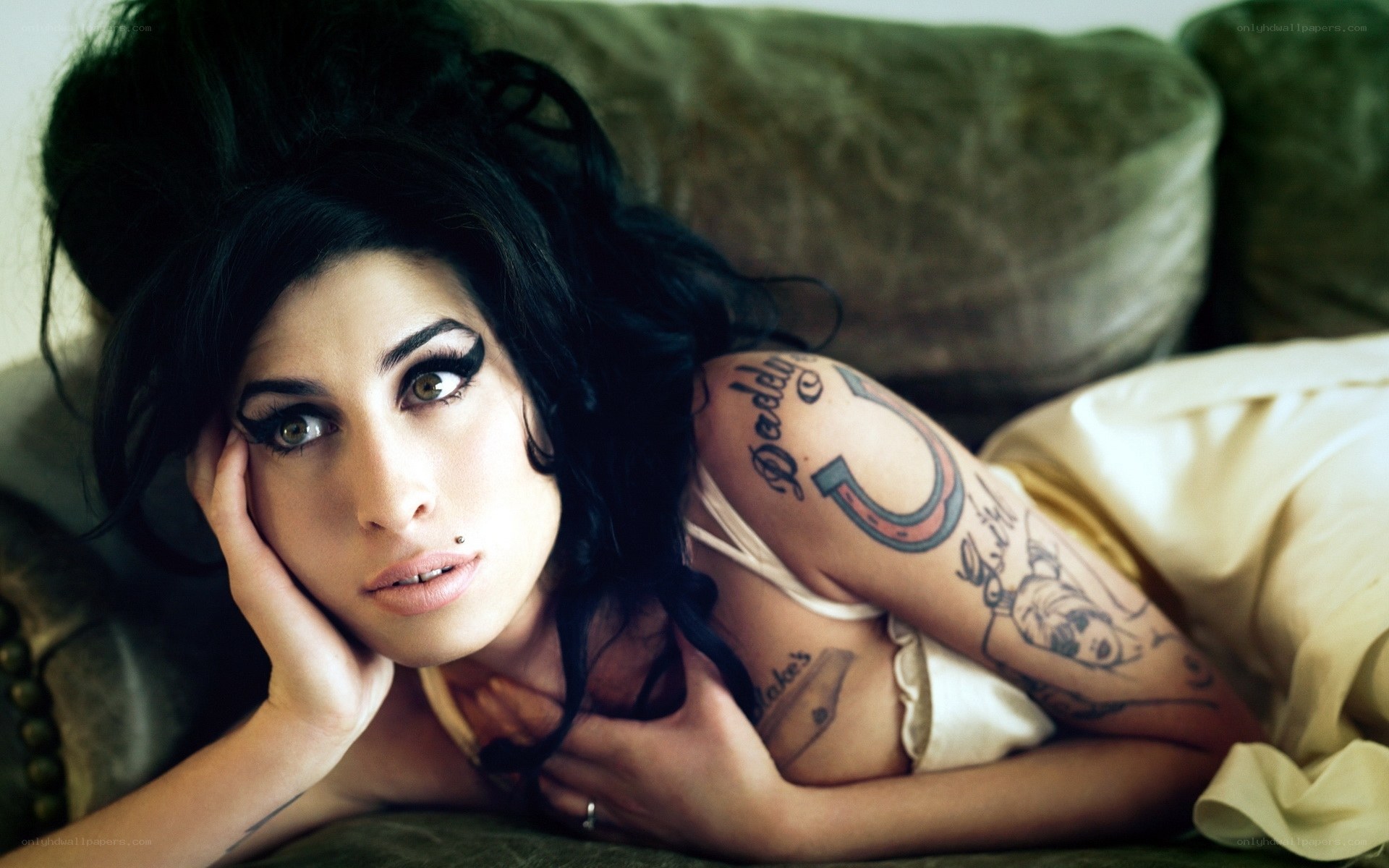 woman with tattoos on couch
