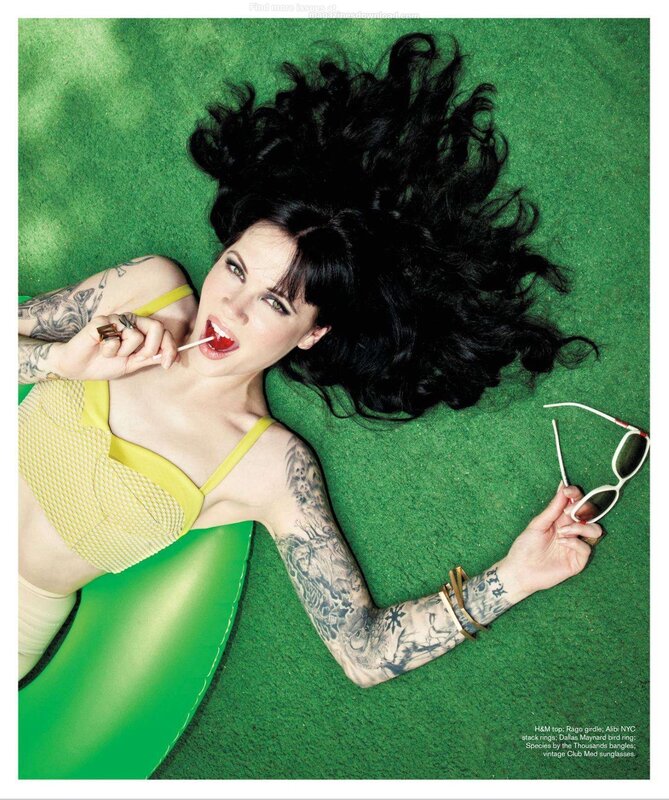 woman with tattoos on green grass
