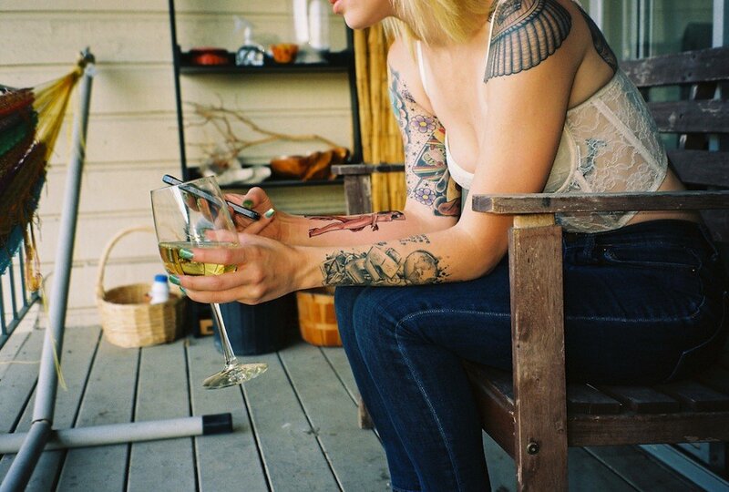 woman with tattoos on porch