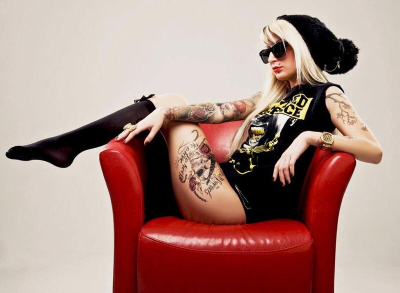 woman with tattoos on red chair