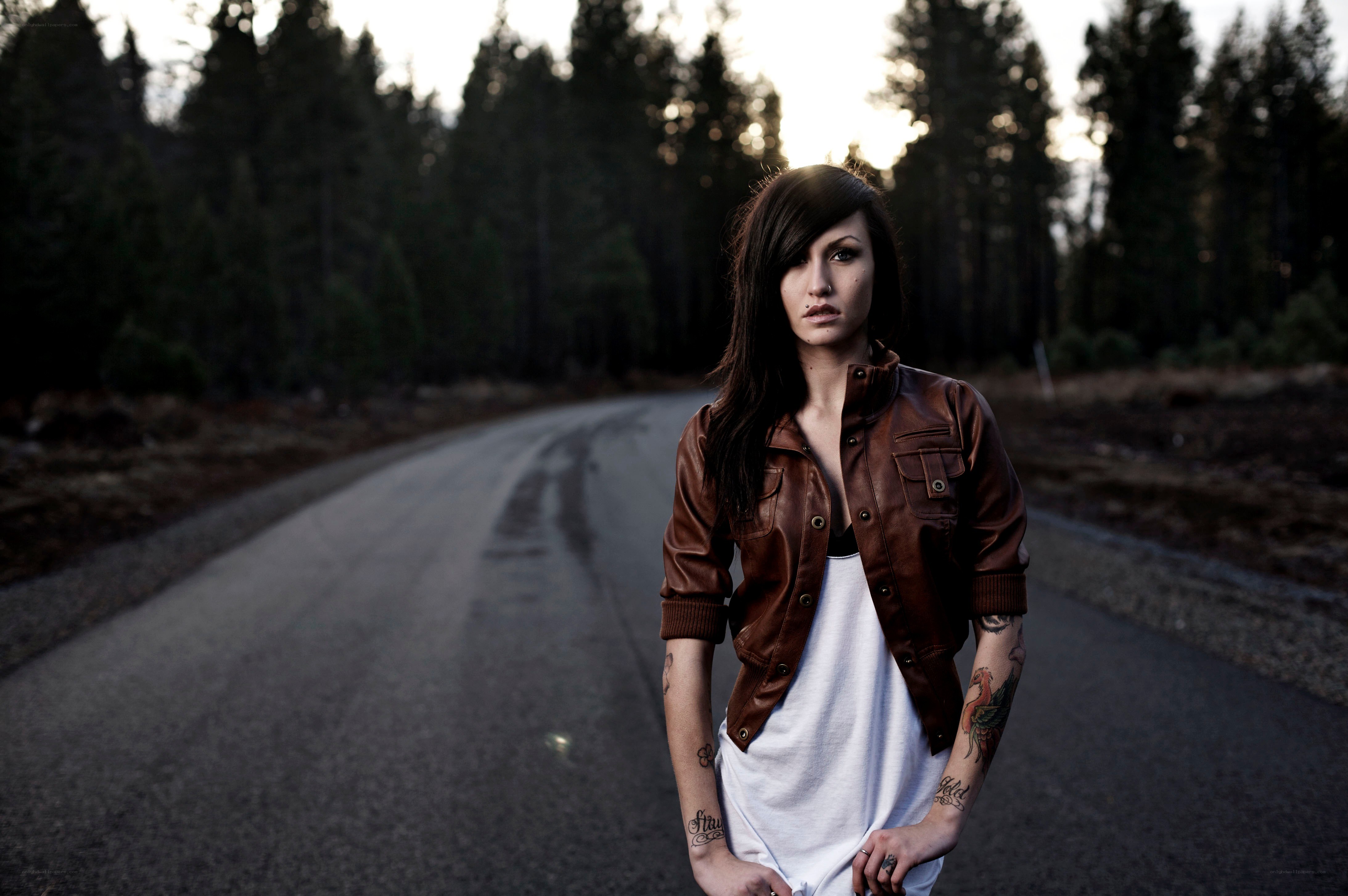 woman with tattoos on road