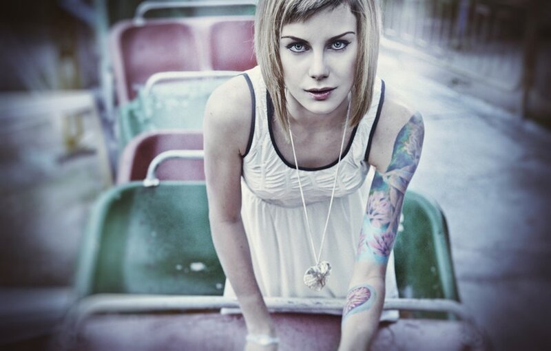 woman with tattoos on roller coaster