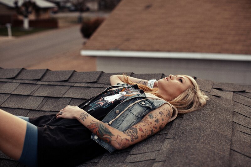 woman with tattoos on roof
