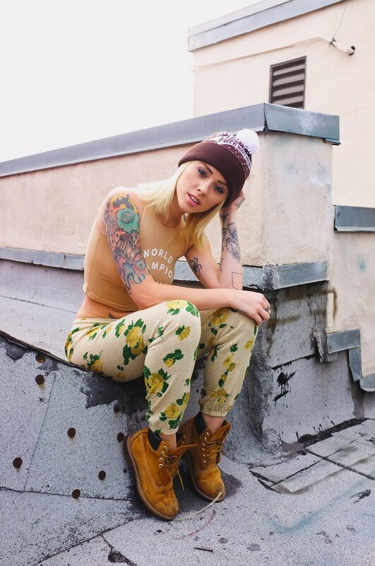 woman with tattoos on rooftop