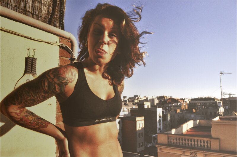 Woman with tattoos on rooftop