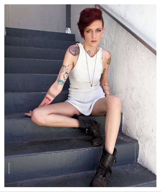woman with tattoos on stairs