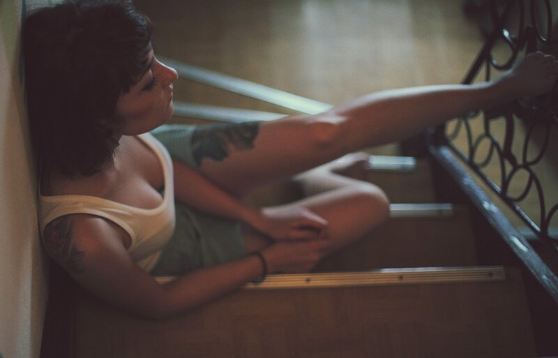 woman with tattoos on stairs