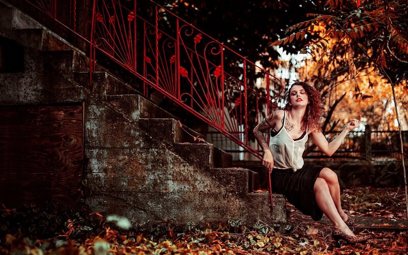 woman with tattoos on stairs