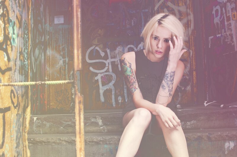 woman with tattoos on steps