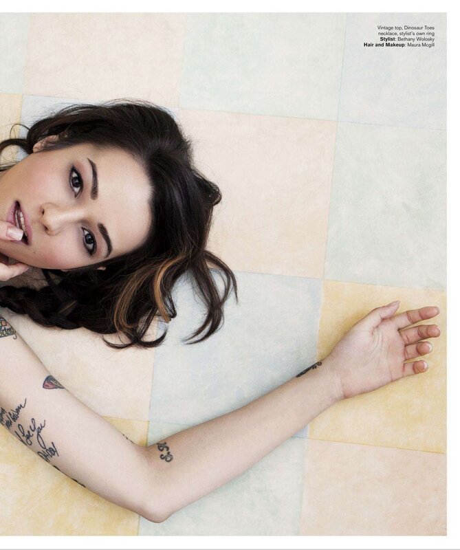 woman with tattoos on tiled floor