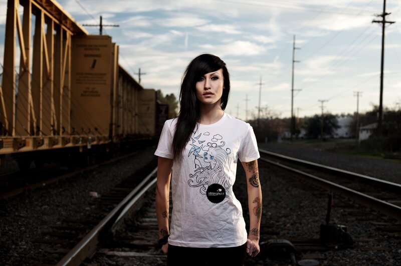 woman with tattoos on train tracks
