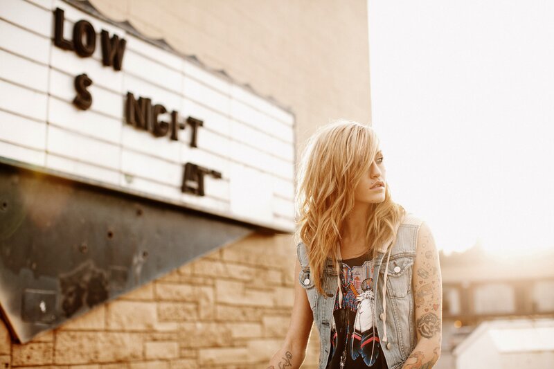 woman with tattoos outside theater