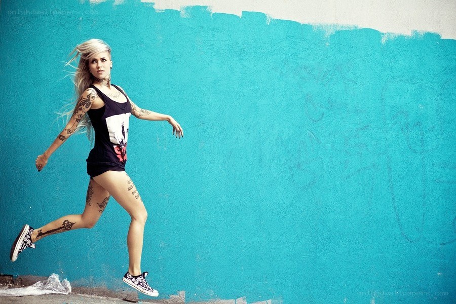 woman with tattoos running