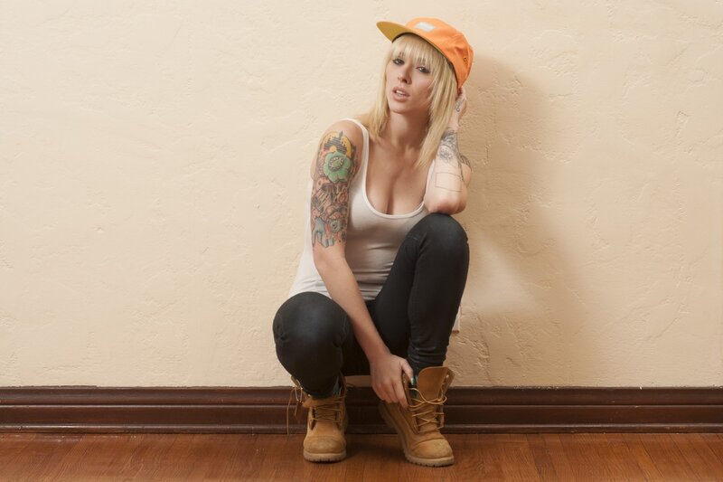 woman with tattoos sitting on floor