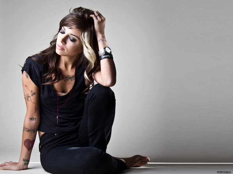 woman with tattoos sitting on floor