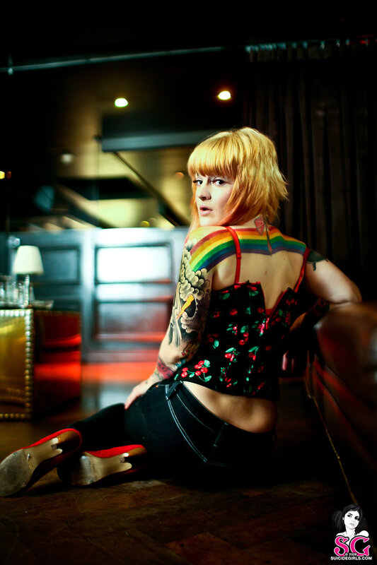 woman with tattoos sitting on floor