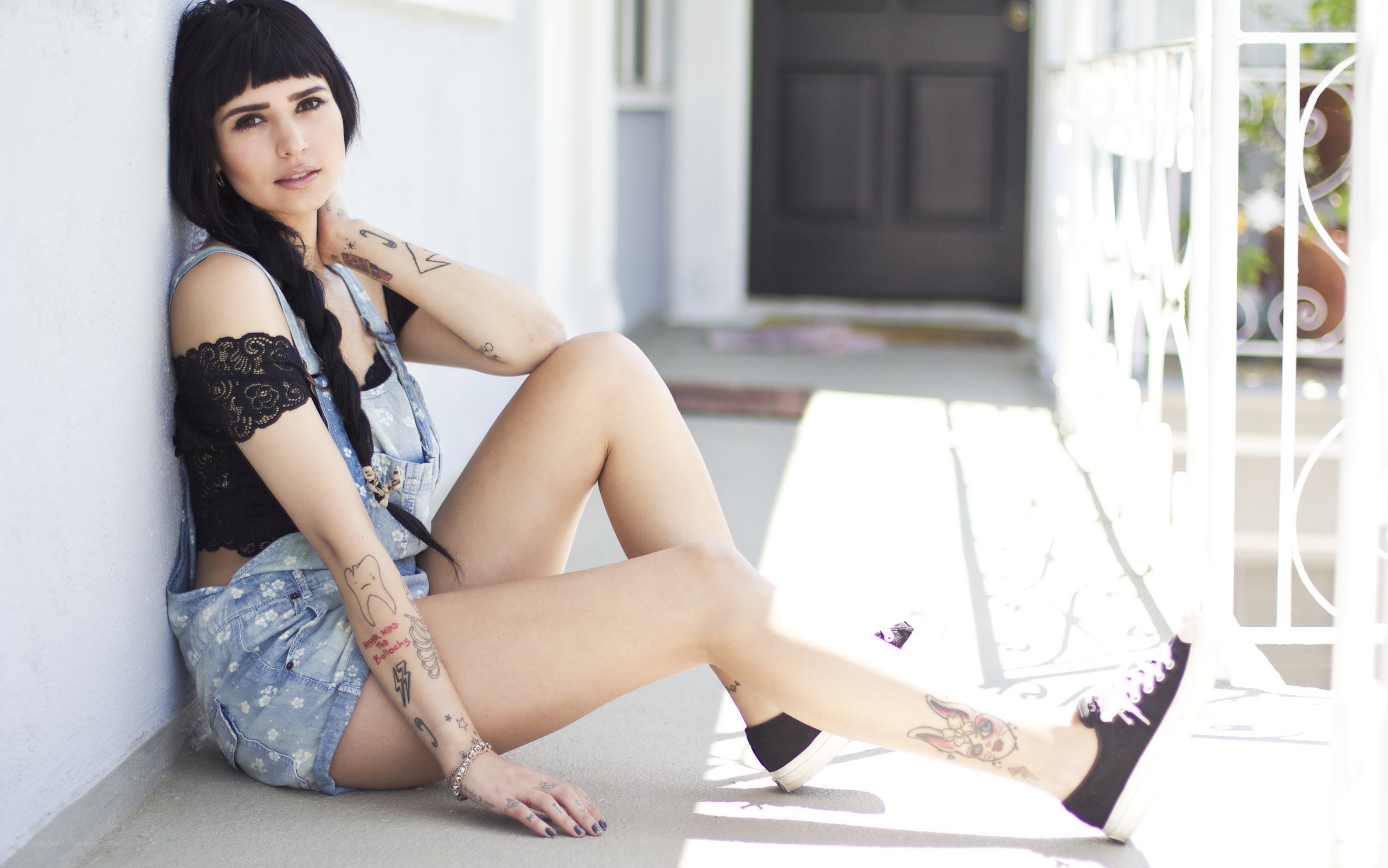 woman with tattoos sitting outside
