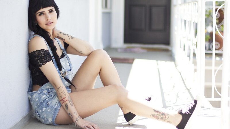 woman with tattoos sitting outside