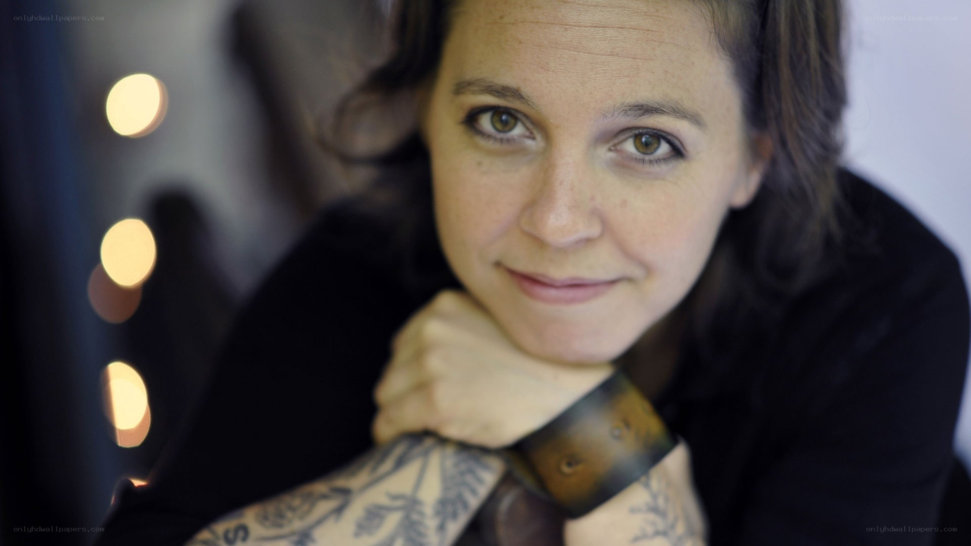 woman with tattoos smiling