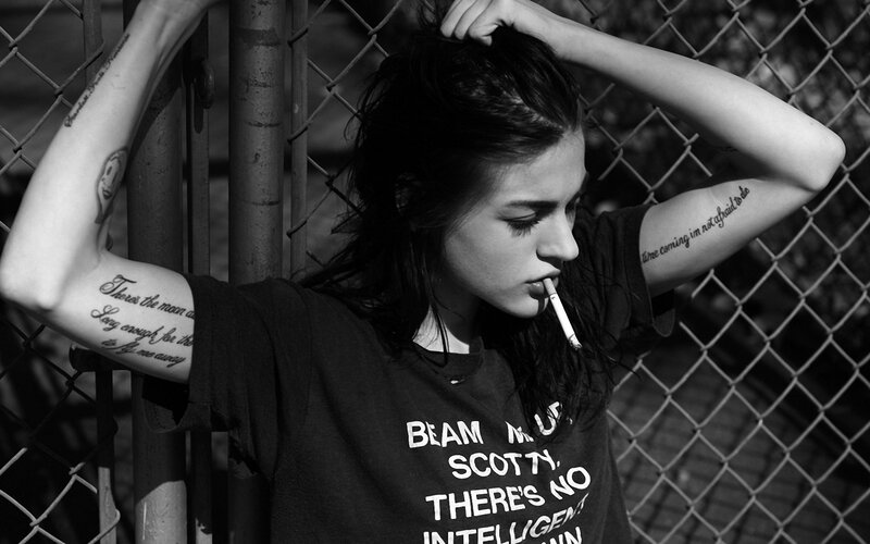 woman with tattoos smoking