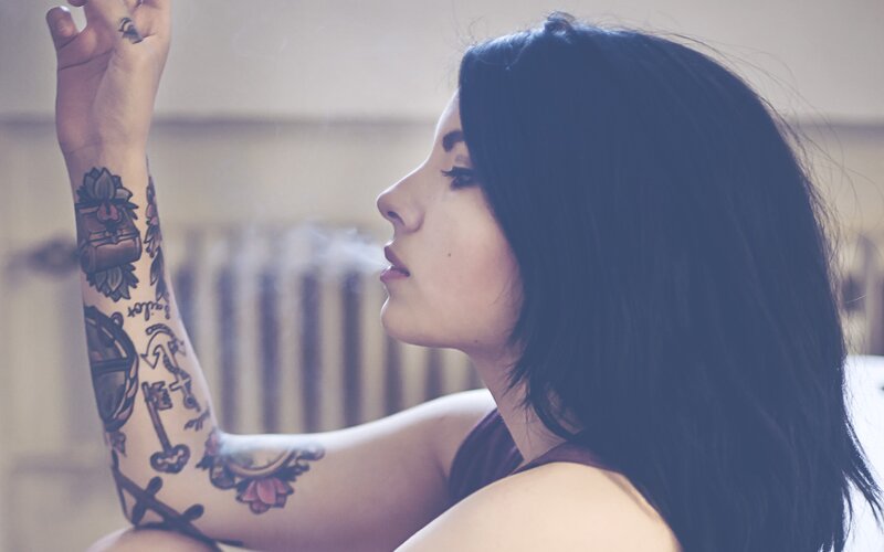 woman with tattoos smoking