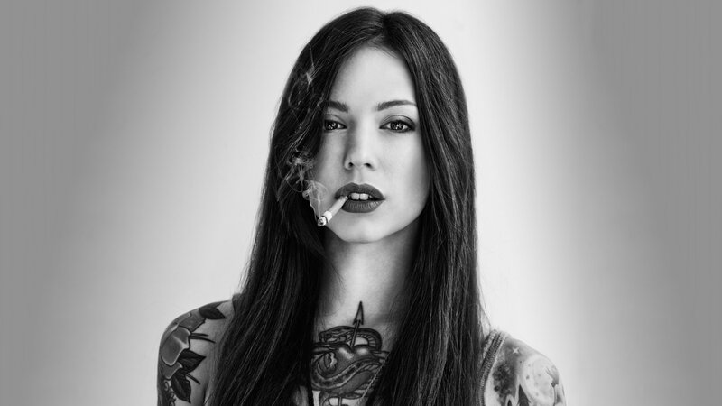 woman with tattoos smoking cigarette