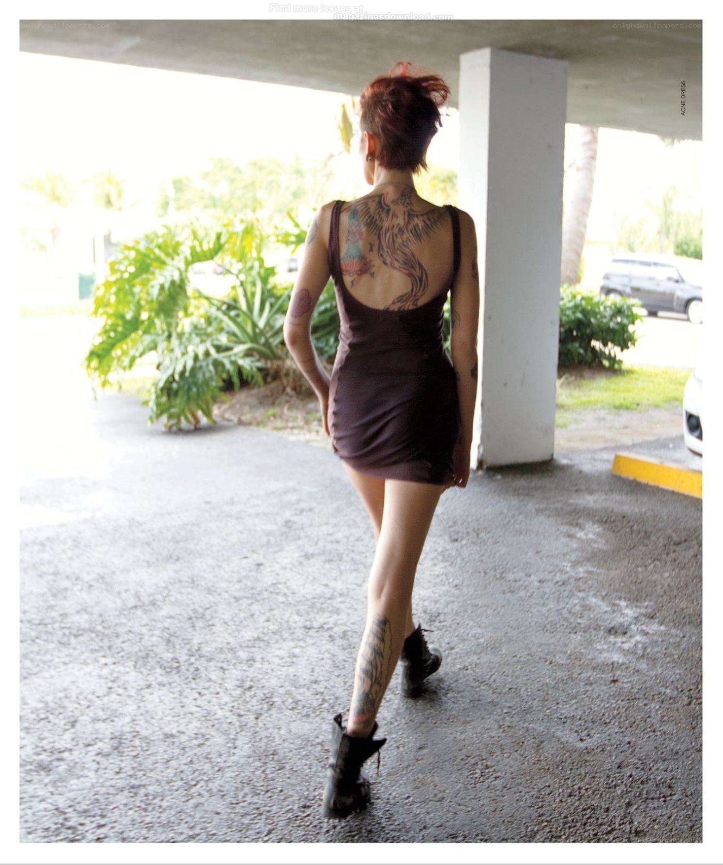 woman with tattoos walking away