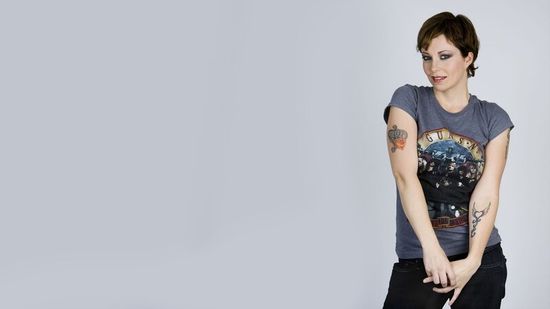 woman with tattoos wearing band t-shirt