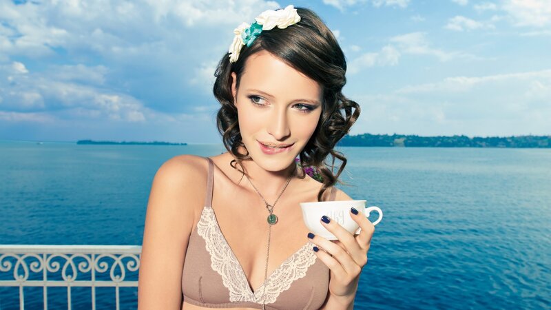 Woman with tea by the water