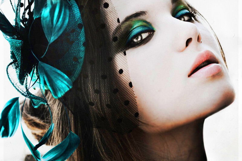 woman with teal makeup and veil