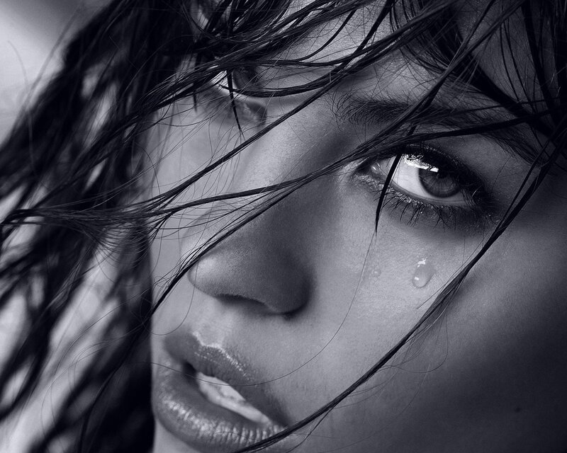 woman with tear in eye