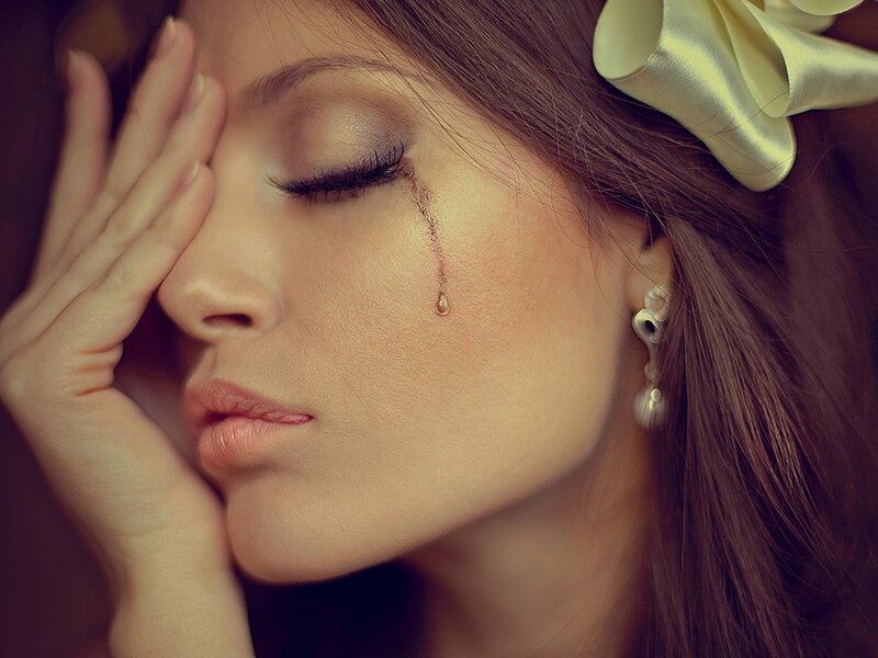 woman with tear on cheek