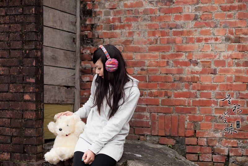 woman with teddy bear and earmuffs