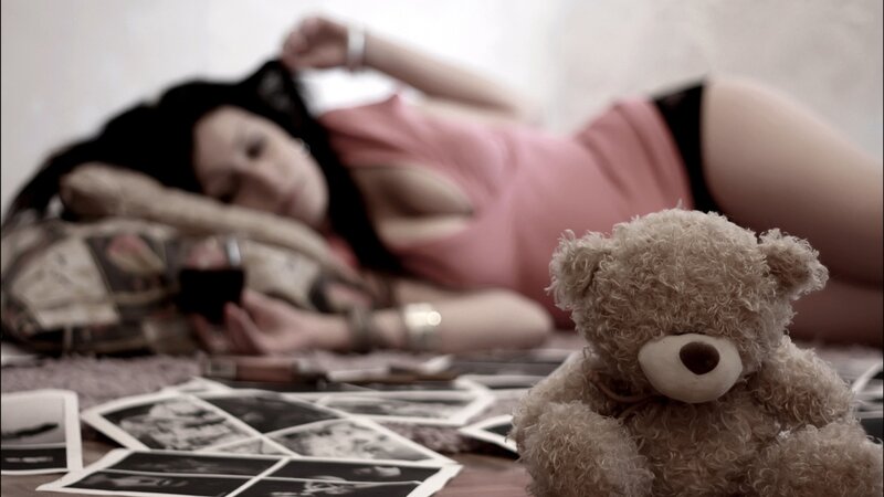 Woman with teddy bear and photos