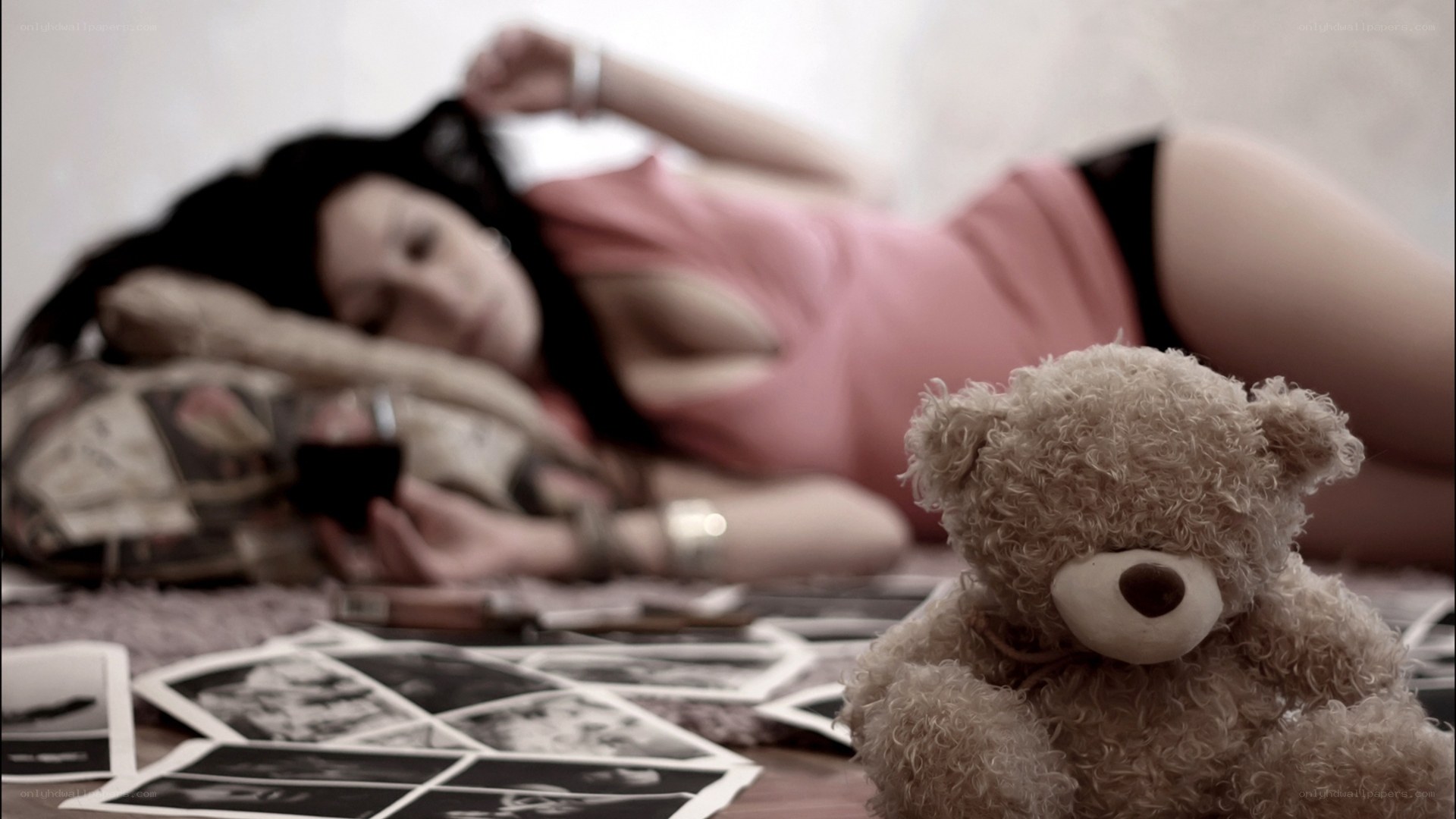 Woman with teddy bear and photos