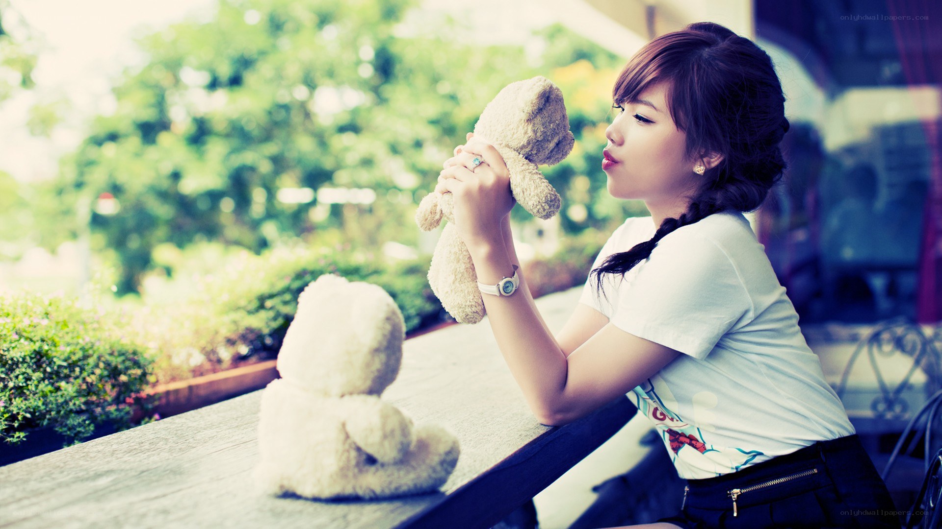 woman with teddy bear at table