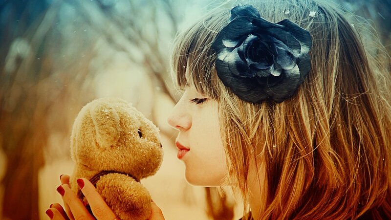 woman with teddy bear in snow