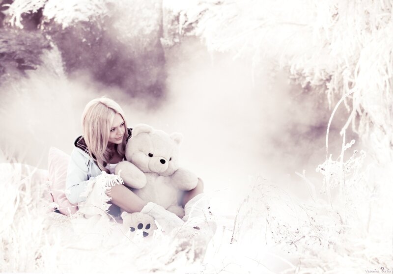 Woman with teddy bear in snow