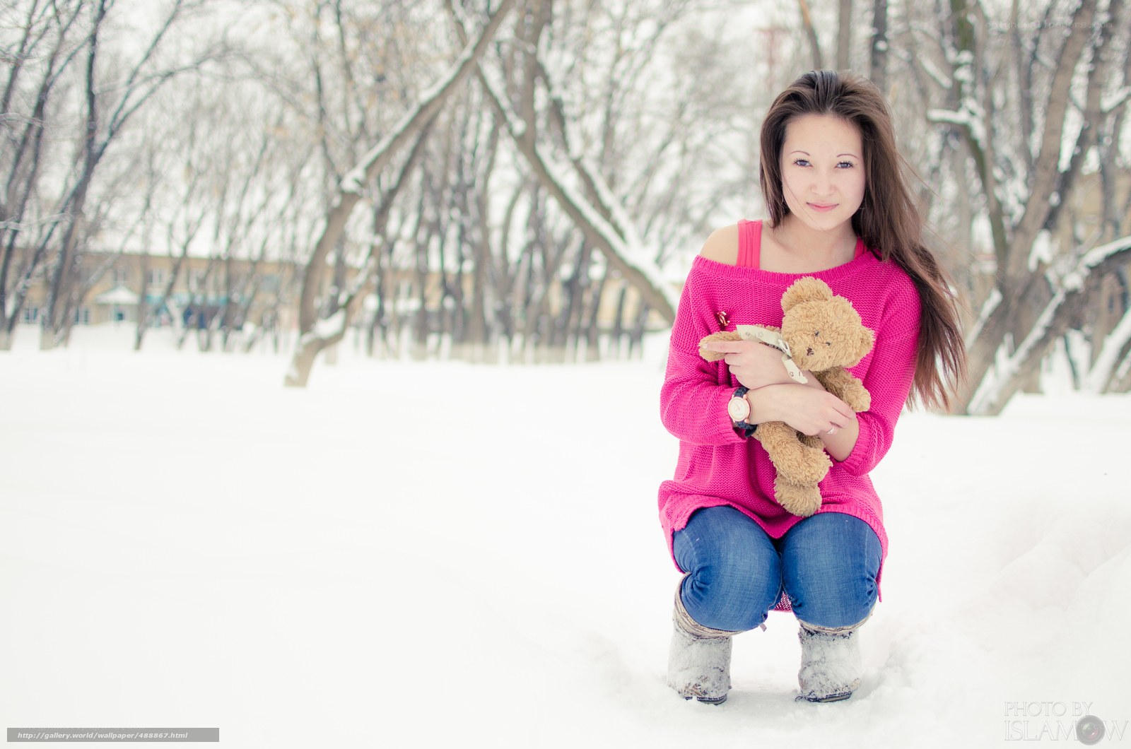 Woman with teddy bear in snow