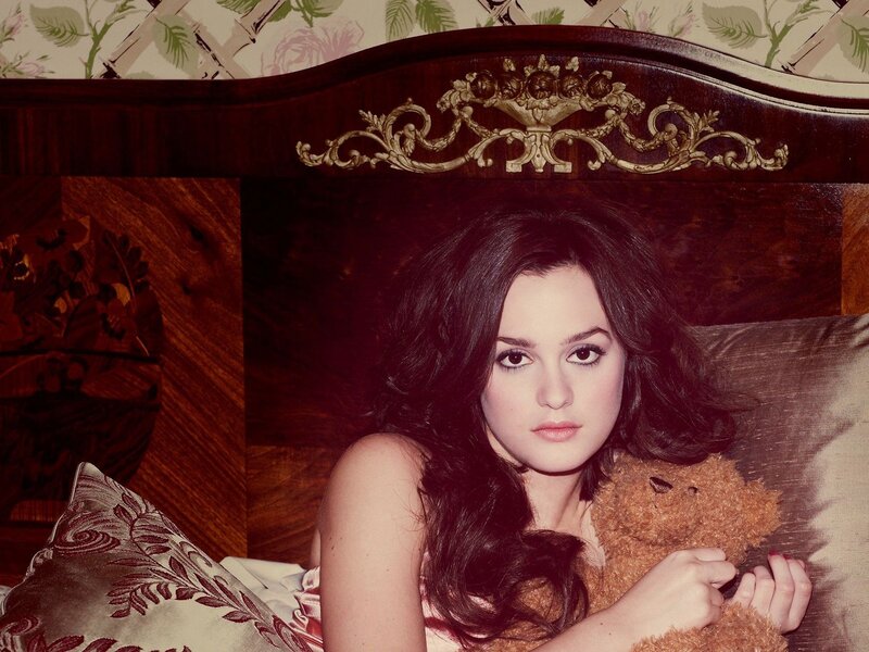 woman with teddy bear on bed