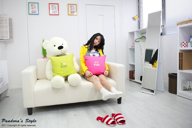 Woman with teddy bear on sofa