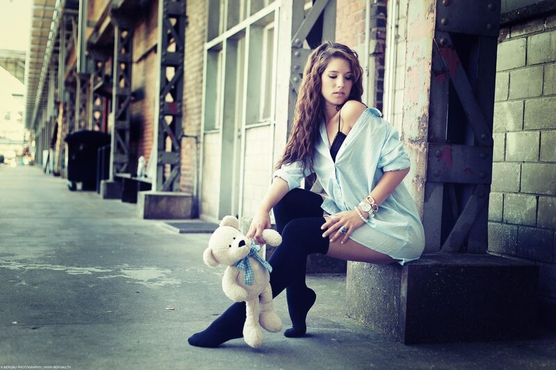Woman with teddy bear on street